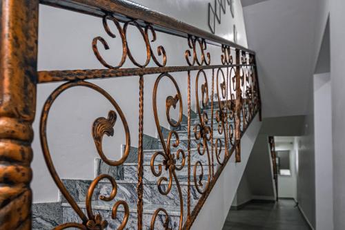 a stairway with a wrought iron railing at Quest Boutique Hotel in Gwarinpa