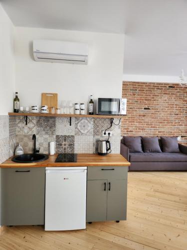 a kitchen with a counter top in a living room at Old Gold Anteon in Tbilisi City