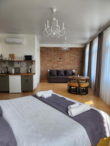 a bedroom with a large bed and a living room at Old Gold Anteon in Tbilisi City