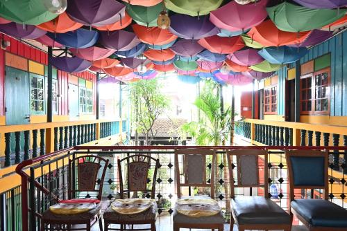 a room with chairs and a ceiling with umbrellas at MARIA Guesthouse in Phra Nakhon Si Ayutthaya