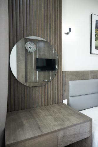 a bedroom with a table with a mirror on the wall at Van Nam Hotel in Ha Long
