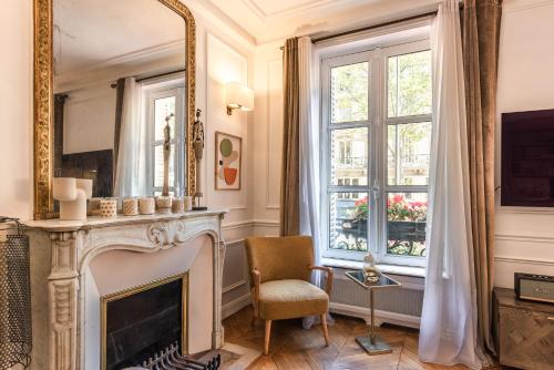 uma sala de estar com lareira e espelho em Outstanding Apartment - 8 Guests between Tour Eiffel and Invalides em Paris