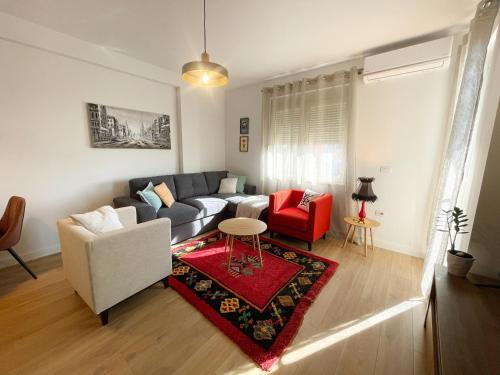 a living room with a couch and a table at Metro Suites in Tirana