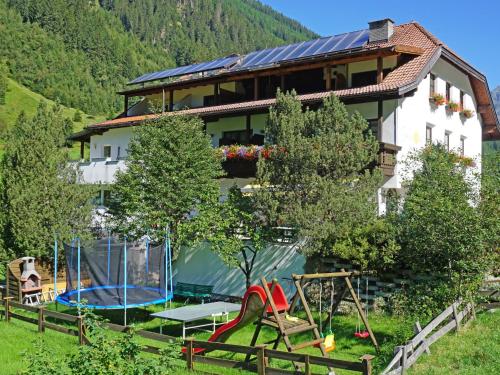 a house with a playground in front of it at Apartment Top 2 by Interhome in Kaunertal