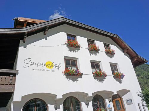a white building with flower boxes on it at Apartment Top 2 by Interhome in Kaunertal