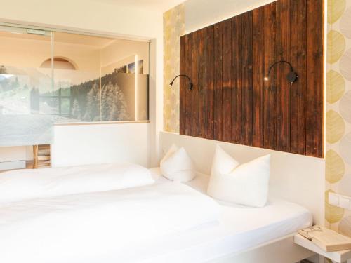 two beds in a room with a window and white pillows at Apartment Top 2 by Interhome in Kaunertal