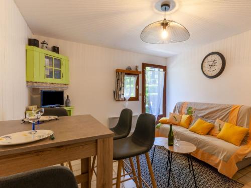 a living room with a couch and a table at Apartment Les Manoirs de la Côte by Interhome in Varaville