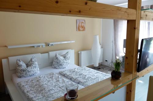 a bedroom with a bed and a tv on a table at Ferienhaus Friedrichswalde in Friedrichswalde