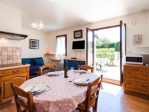 a kitchen and dining room with a table and chairs at Apartment Les Maisons de la Mer by Interhome in Merville-Franceville-Plage