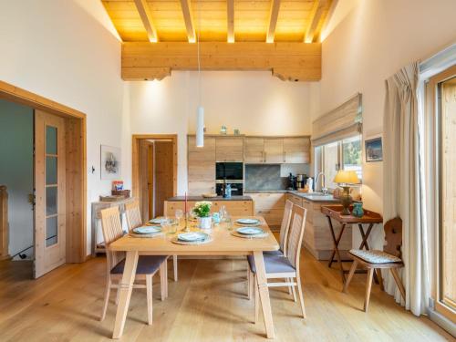 a kitchen and dining room with a wooden table and chairs at Apartment Orleans by Interhome in Hinterthal