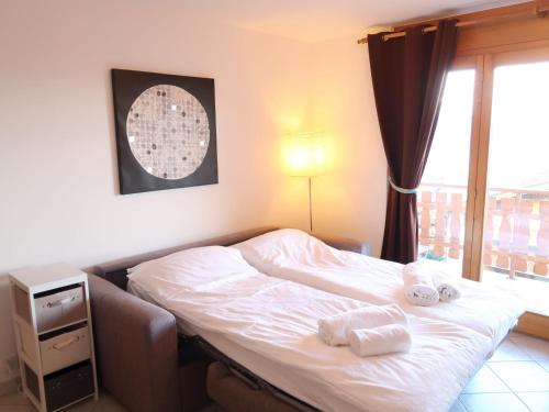 a bedroom with a bed with towels on it at Apartment Grand Panorama A5 by Interhome in Nendaz
