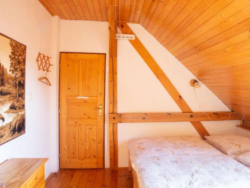 a bedroom with a bed and a wooden ceiling at Holiday Home Vlkov by Interhome in Veselí nad Lužnicí