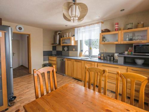 a kitchen with a wooden table and wooden chairs at Holiday Home Tanvald by Interhome in Tanvald