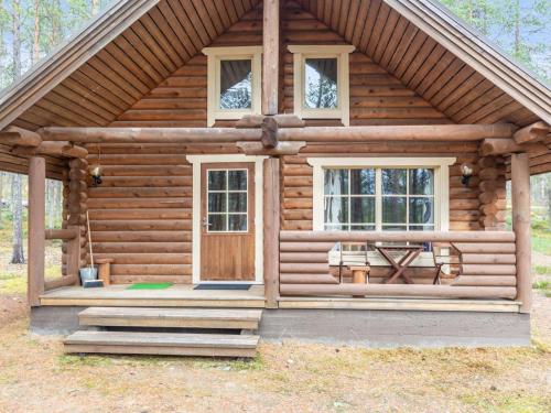 a log cabin with a front door and windows at Holiday Home Lumomarja by Interhome in Pyhätunturi