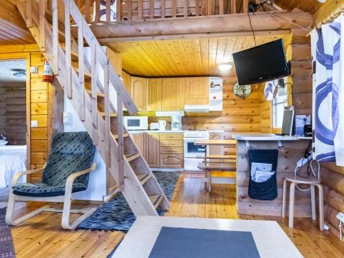 a living room with a staircase in a log cabin at Holiday Home Lumomarja by Interhome in Pyhätunturi