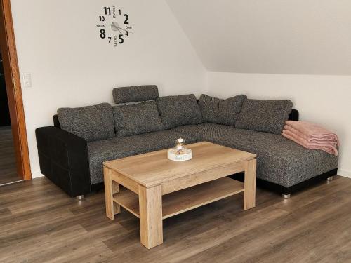 a living room with a couch and a coffee table at Apartment Am Meintetal by Interhome in Lügde