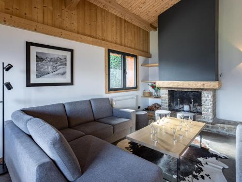 a living room with a couch and a fireplace at Holiday Home L'Adret by Interhome in Saint-Gervais-les-Bains
