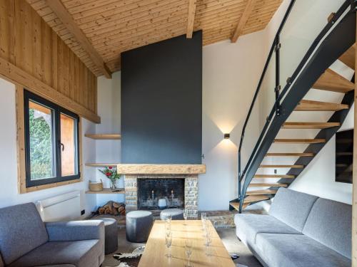a living room with a couch and a fireplace at Holiday Home L'Adret by Interhome in Saint-Gervais-les-Bains