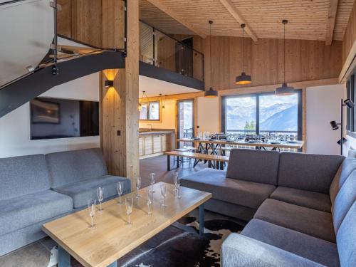 a room with couches and a table with glasses on it at Holiday Home L'Adret by Interhome in Saint-Gervais-les-Bains