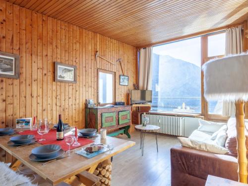 a living room with a table and a couch at Apartment Le Grande Motte - Le Lac by Interhome in Tignes