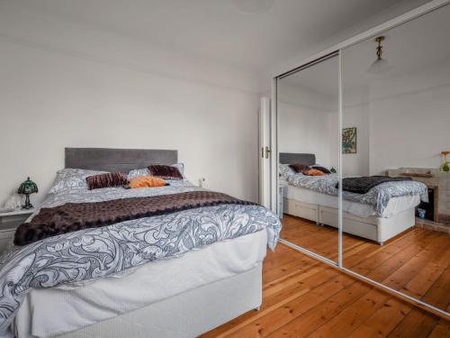 a bedroom with a large bed and a mirror at Holiday Home Sullivan by Interhome in Drumnadrochit