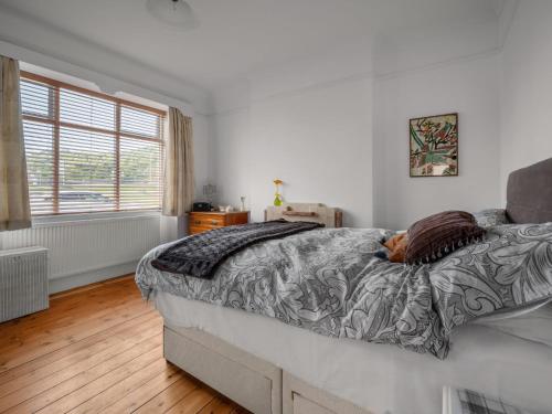 a bedroom with a large bed and a window at Holiday Home Sullivan by Interhome in Drumnadrochit