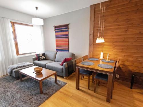 a living room with a couch and a table at Holiday Home Ylläs chalets a104 by Interhome in Ylläsjärvi