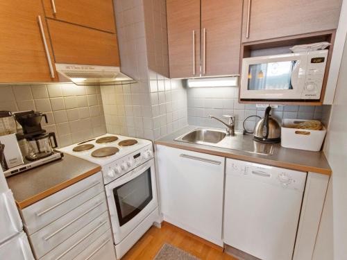 a small kitchen with a stove and a sink at Holiday Home Ylläs chalets a104 by Interhome in Ylläsjärvi