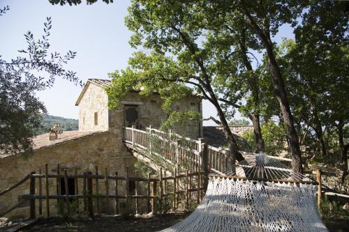 an old building with a fence and a tree at Luxury villa Colle dell'Asinello ,proprietari ,Villa In esclusiva near ORVIETO in Guardea