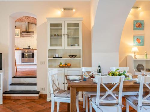 a kitchen and dining room with a table and chairs at Apartment Ca du Ponte by Interhome in Dolcedo