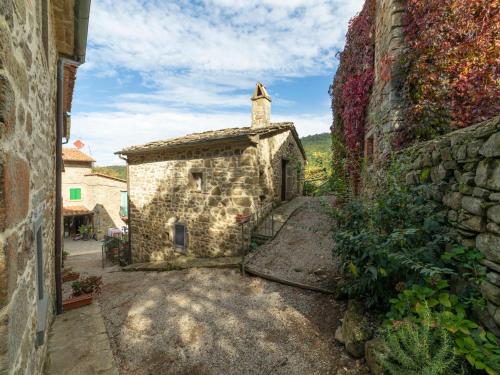 an old stone building with a cross on top of it at Holiday Home Il Feudo by Interhome in Poggioni