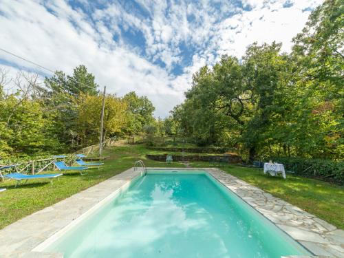 a swimming pool in the yard of a house at Holiday Home Il Feudo by Interhome in Poggioni