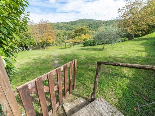a wooden bench in a field with a fence at Holiday Home Il Feudo by Interhome in Poggioni
