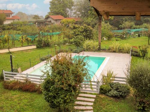 a swimming pool in a yard with a playground at Villa Giuseppina by Interhome in Besozzo