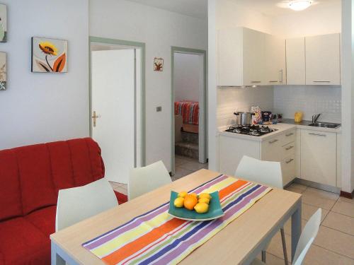 a kitchen and a table with a bowl of fruit on it at Apartment Primula by Interhome in Bibione