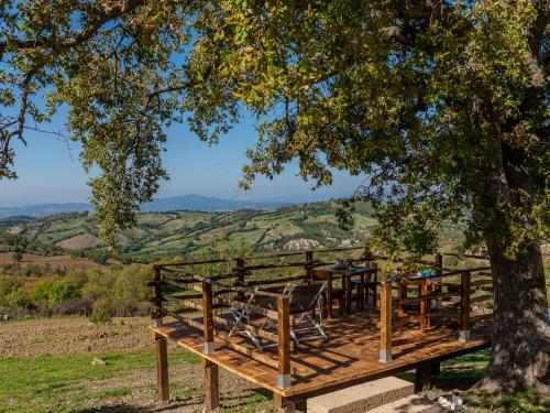 a wooden deck with a table and chairs under a tree at Holiday Home Meridiana by Interhome in Cana