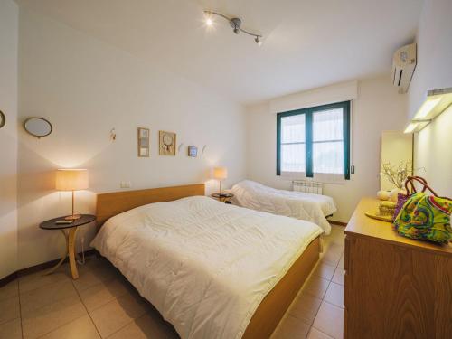 a bedroom with two beds and a window at Apartment Appartamento Pietrasanta by Interhome in Pietrasanta