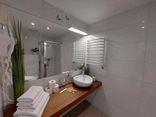 een witte badkamer met een wastafel en een spiegel bij Apartament Sienna Czarna Góra STUBAI 29 in Siena