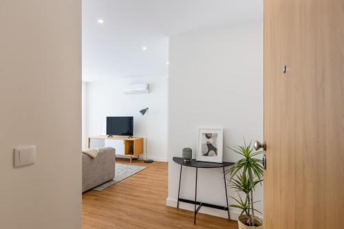 a living room with a table and a couch at Pestana Apartments - Premium in Porto
