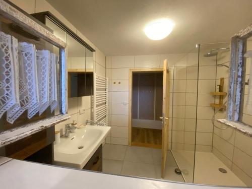 a bathroom with a sink and a shower at Panoramahotel Lilienstein in Königstein an der Elbe