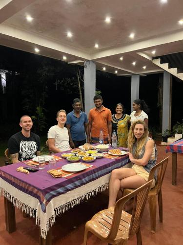 a group of people sitting around a dinner table at Isanka Lion Lodge in Sigiriya