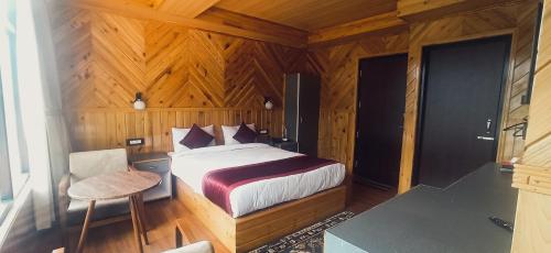 a bedroom with a bed in a wooden room at Rufina Lachung Kunga in Lachung