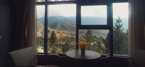 a table in front of a window with a view at Rufina Lachung Kunga in Lachung