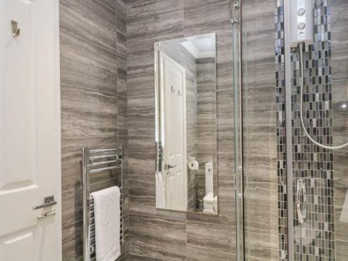 a bathroom with a shower with a glass door at No 3 Victoria Apartment in Bowness-on-Windermere