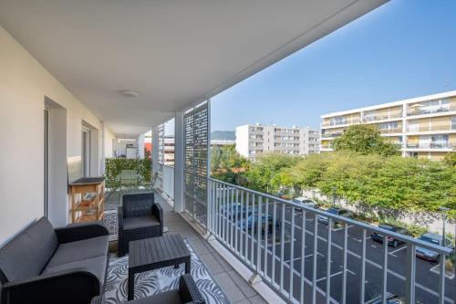 a balcony with chairs and a view of a city at Air-conditioned flat with terrace garage and close to beaches in Cannes