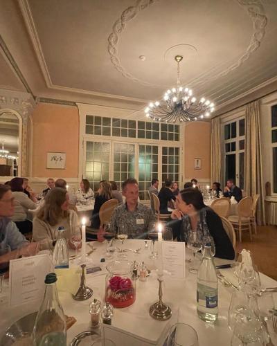 a group of people sitting at a table in a restaurant at Grand Hôtel des Rasses & Wellness in Les Rasses