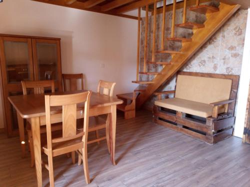 a dining room with a table and chairs and a staircase at Casa da Porta velha in São Gião