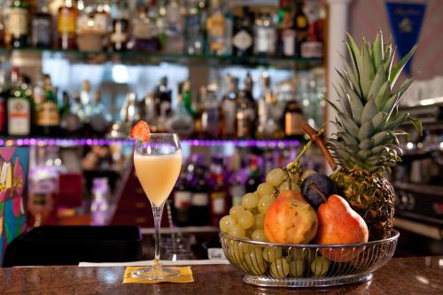 a bowl of fruit and a glass of juice on a bar at Hotel Terme Venezia in Abano Terme