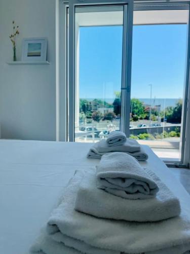 a pile of towels sitting on top of a room with a window at Marina House Rome Airport - Sea View in Fiumicino