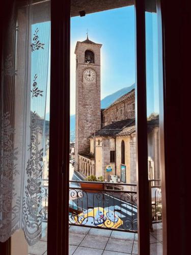a view of a clock tower from a window at Mondo D'Oro in Macugnaga